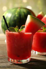 Glasses of watermelon juice on wooden table, closeup
