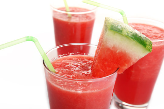 Glasses of watermelon juice isolated on white
