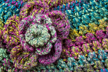 Close up of a crochet flower on a hand-made winter hat