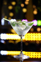 Glass of cocktail on bar background