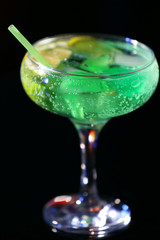 Glass of cocktail on dark background