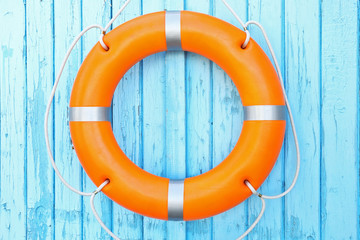A life buoy on blue wooden background