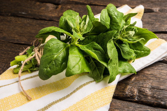 Spinach leaves on a wooden background