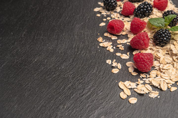 Obraz na płótnie Canvas Healthy breakfast and berries on slate background, close-up