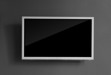 Wide screen television on grey wall background