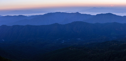 Panoramic view of skyline with mist and mountain at Doi Pha Hom Pok in Chiang Mai, Thailand.