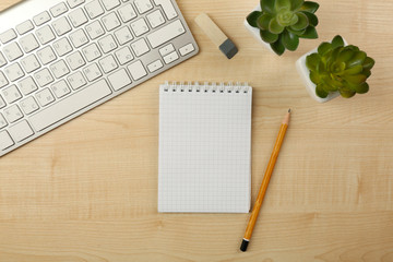 Fototapeta na wymiar White keyboard and notebook on the desk