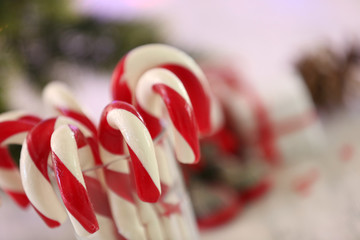 Fototapeta na wymiar Christmas Candy Canes in glass on table on light background