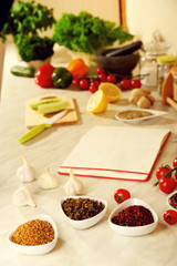 Variety of spices in ceramic containers on the kitchen table