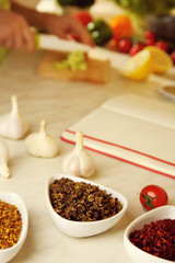 Variety of spices in ceramic containers on the kitchen table