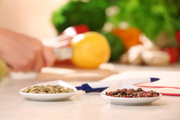 Variety of spices in ceramic containers on the kitchen table