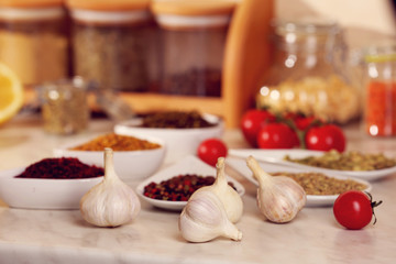 Garlic and variety of spices on the kitchen table