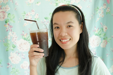 Portrait of asian woman drink ice coffee in the coffee shop