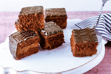 Served table with chocolate cakes on wooden background close-up