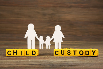 Cutout family and blocks with letters regarding child-custody and family-law concept