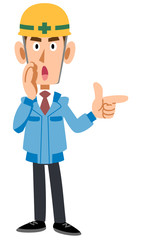 指差して教える建築現場作業員