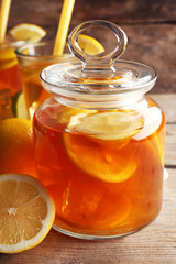 Iced tea with lemon on wooden background