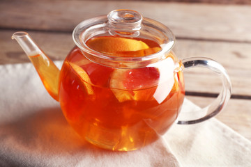 Iced tea with lemon and grapefruit on wooden background