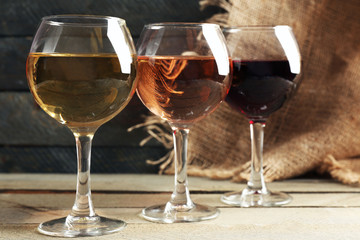 Composition of wine glasses on wooden background