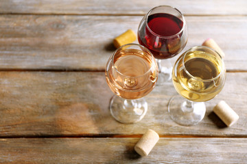 Crystal wine glasses and corks on wooden background
