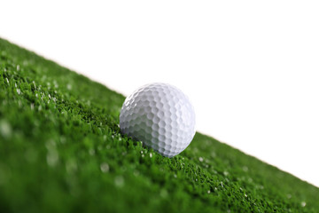 Golf ball on grass isolated on white