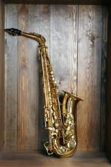 Beautiful golden saxophone on wooden background
