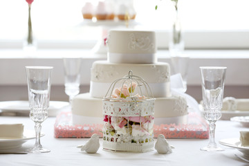 Layered wedding cake on decorated table in restaurant