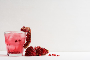 Delicious pomegranate cocktail on the white wooden background