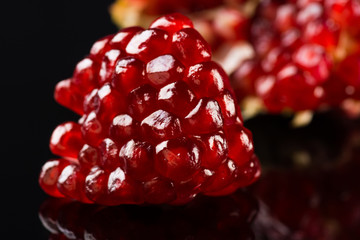 Delicious pomegranate cocktail on the black background