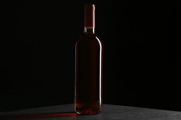 A bottle of wine, on grey-black background