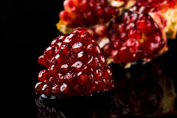 Delicious pomegranate cocktail on the black background