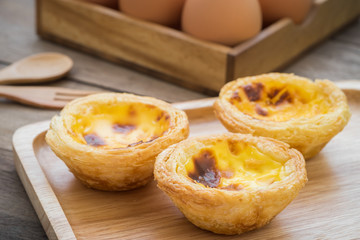 Egg tart on wooden plate