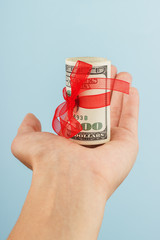 woman hand with money on the blue background