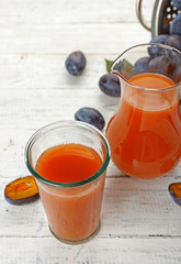 Plum Juice in jar and glass with fresh fruits