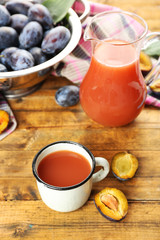 Plum Juice in jar and mug with fresh fruits