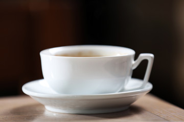 Cup of coffee in the table on defocused background