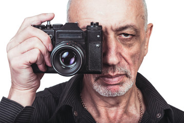 Senior photographer with old film camera on white background