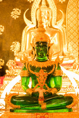 green buddha among other buddhas
