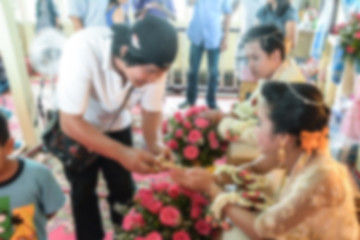 Blur Picture of hand of a bride receiving holy water from elders in thai culture wedding ceremony 