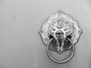Old knocker on gray door in temple thailand