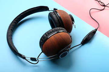Black and brown headphones on pink-blue background