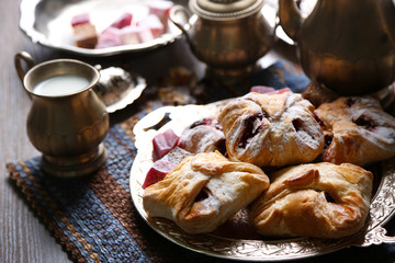 Antique tea-set with Turkish delight and baking on table close-up