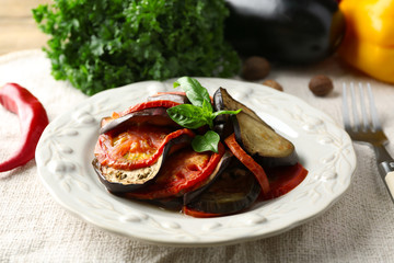 Ratatouille on plate, on table background