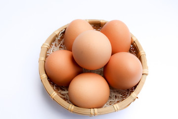  Egg in basket wicker on white background,raw egg