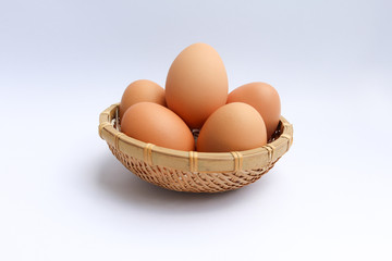  Egg in basket wicker on white background,raw egg