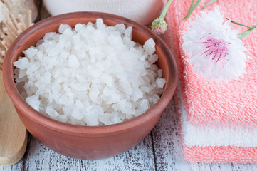 Spa salon with sea salt, towels and flowers