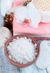 Obraz na płótnie Canvas Spa salon with sea salt, towels and flowers