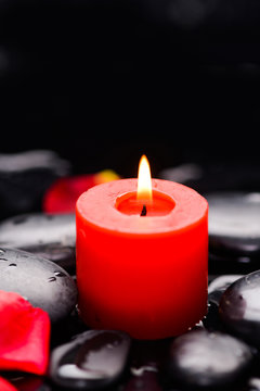 red petals with candle and therapy stones 