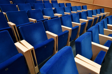 Blue velvet chairs in amphitheater