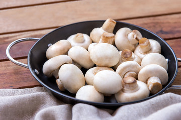 raw champignon in frying pan